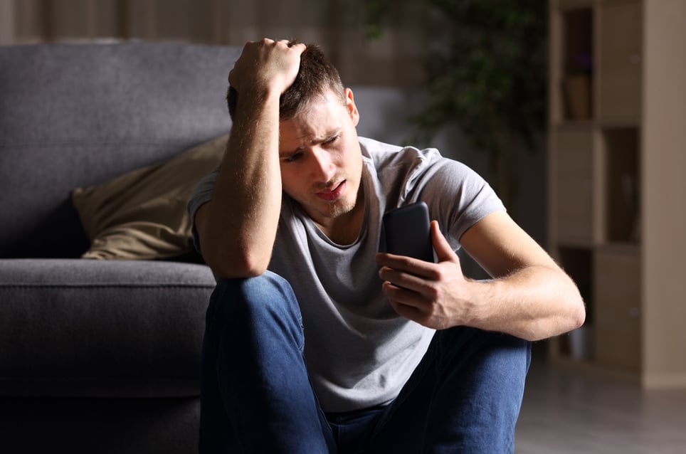 anxious-man-using-his-phone-effects-of-low-resilience