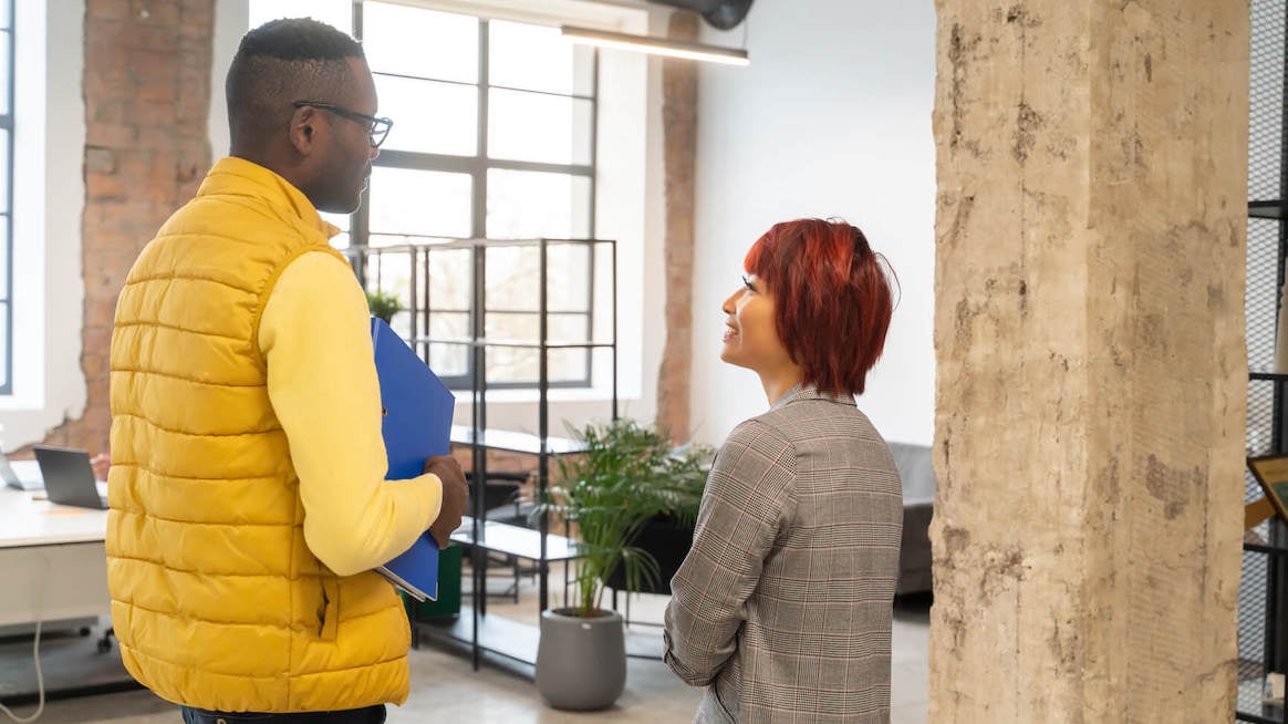 how-to-ask-for-feedback-two-colleagues-in-lobby