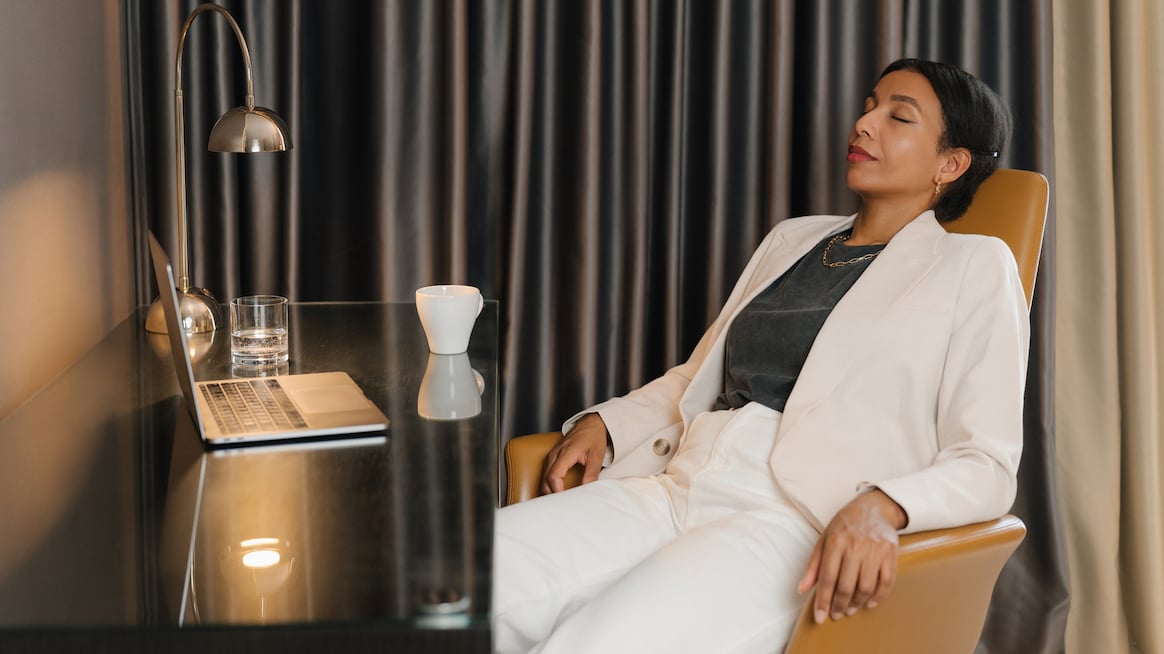 woman-executive-rests-in-desk-chair-crisis-response-impact-on-employees