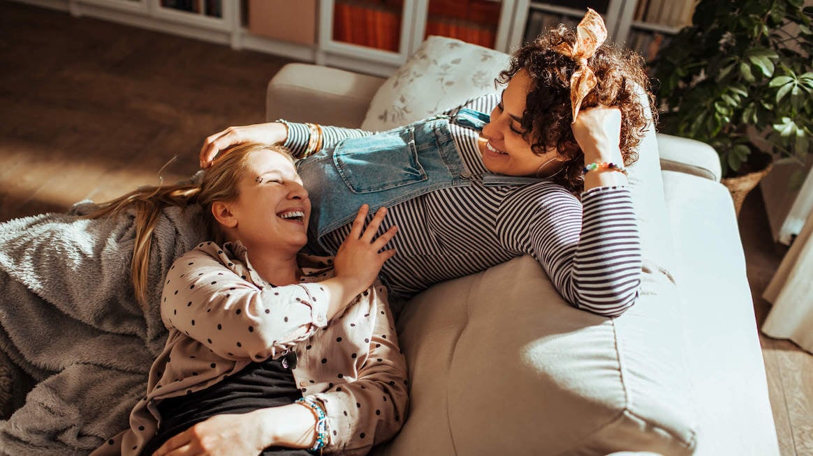 lgbtq-health-disparities-gay-couple-pregnant-on-couch