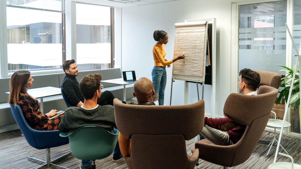 presentation-feedback-examples-woman-presenting-at-meeting