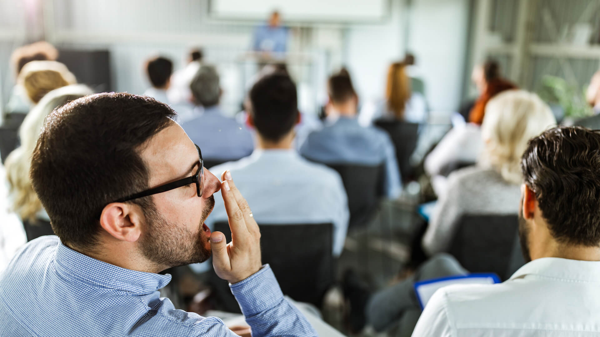 reading-the-room-a-person-yawns-in-a-boring-meeting