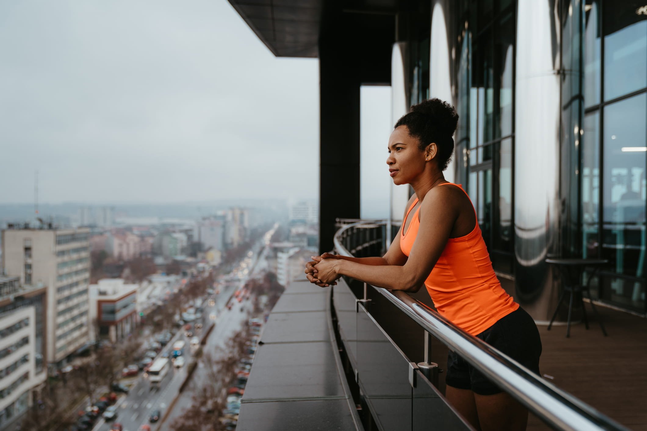Woman-looking-at-view-from-building-terrace-how-resilience-can-help-you-with-stress