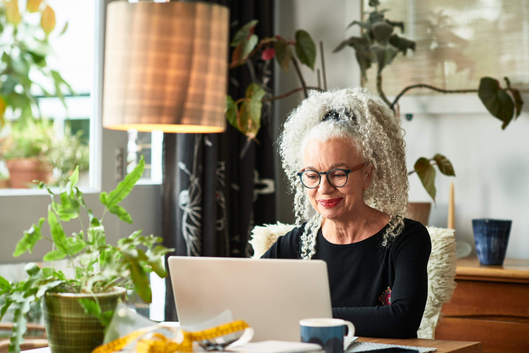 woman typing on her computer smiling