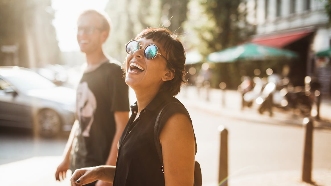 busy-woman-in-sunglasses-laughs-on-street-how-to-do-inner-work