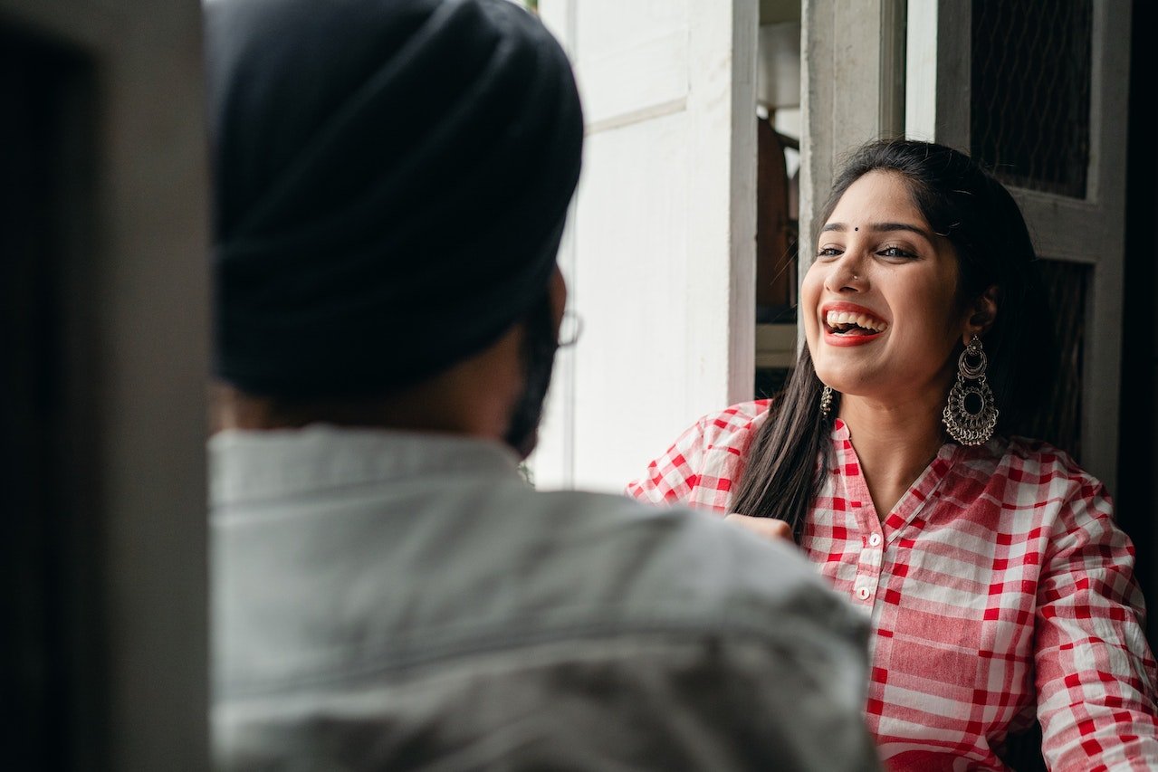 woman-smiling-and-listening-to-friend-talk-human-resources-skills