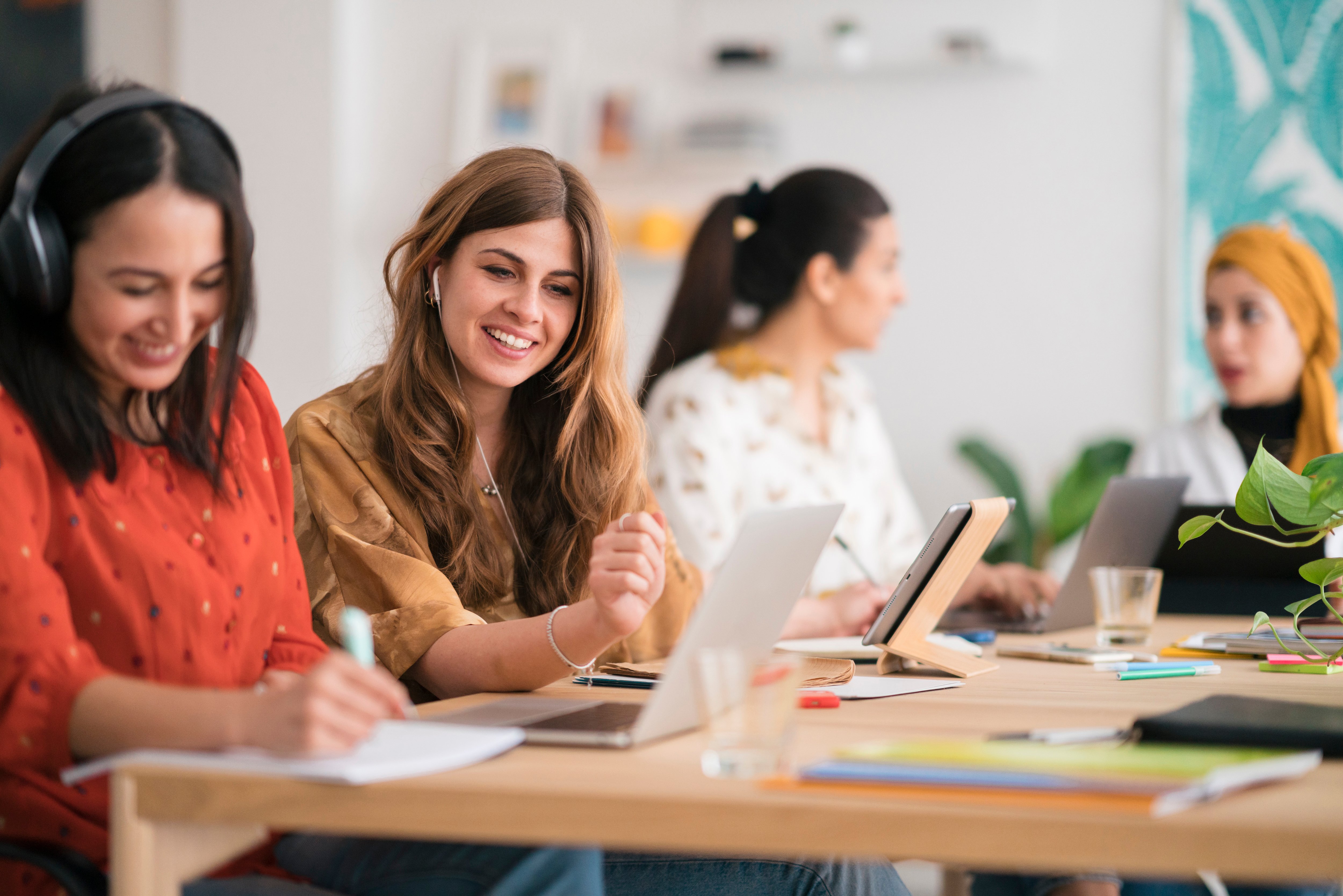 women working at desk - work values